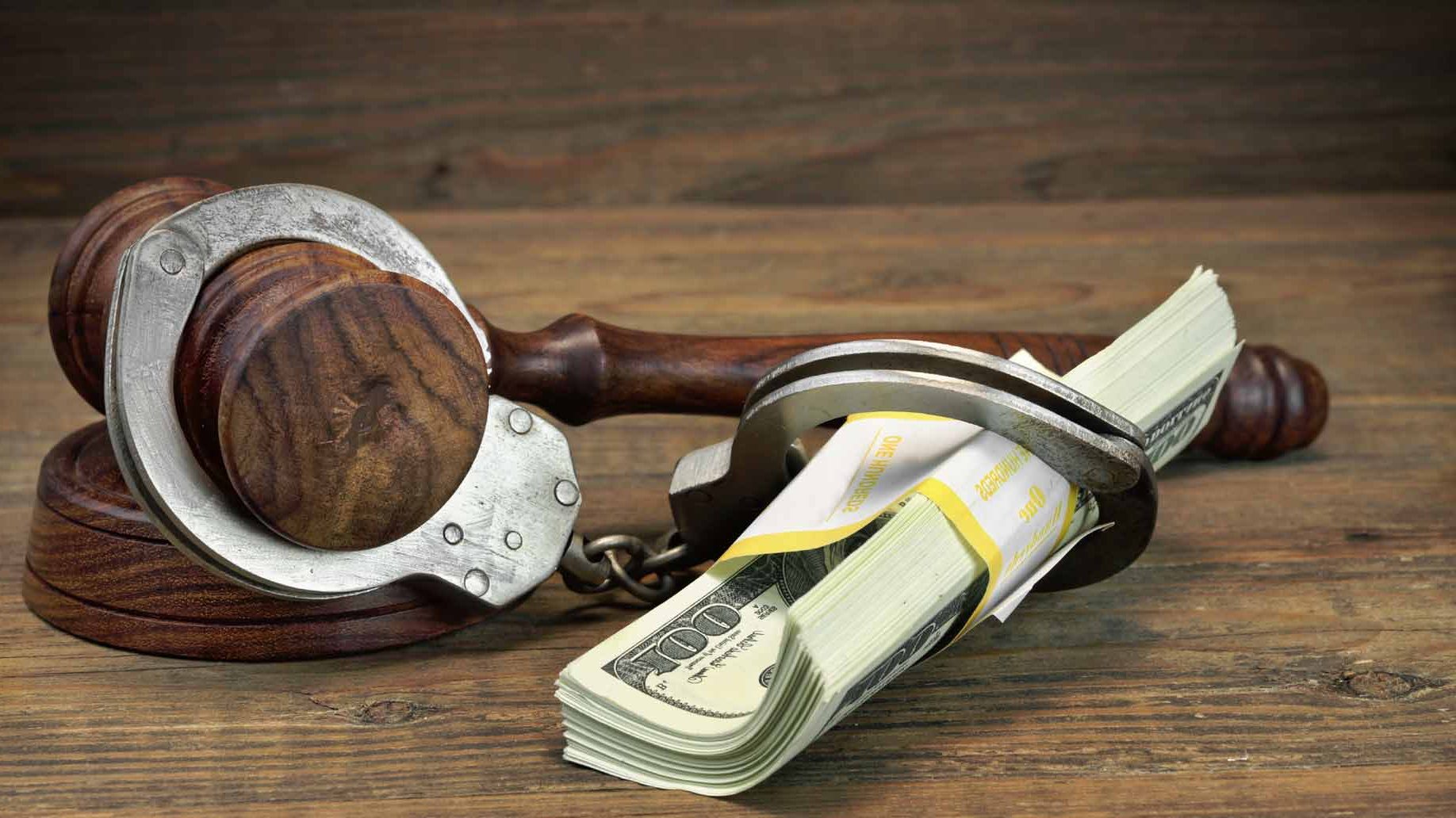 handcuffs, dollars and gavel