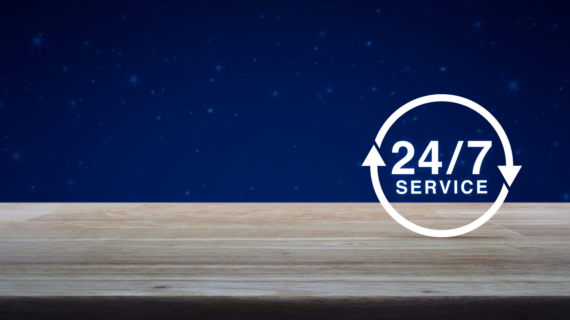 24 hours service icon on wooden table over fantasy night sky and moon