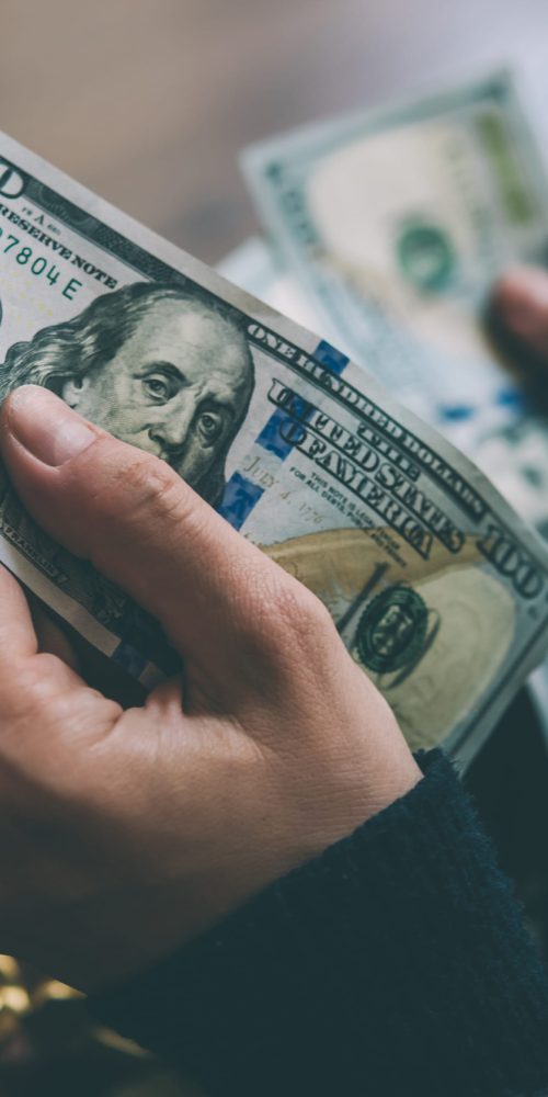 Girl's hands holding dollar bills