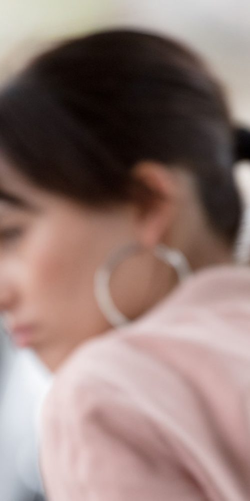 african american policeman arresting woman and talking on portable radio