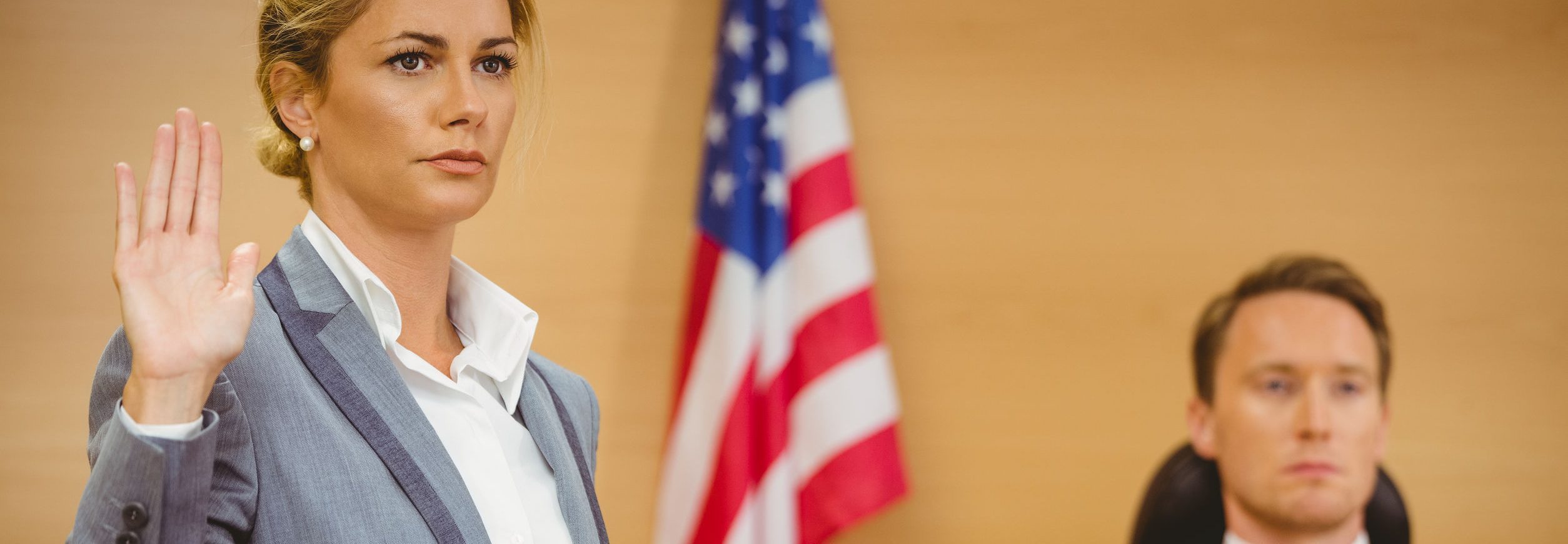 Witness swearing on the bible telling the truth in the court room